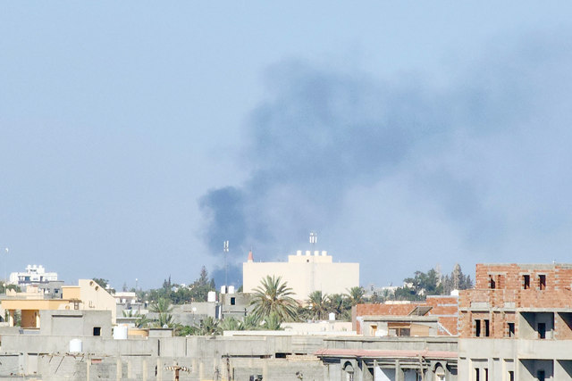 Smoke billows amid clashes between armed groups affiliated with Libya's Tripoli-based Government of National Unity in the Libyan capital on Tuesday (AFP photo)