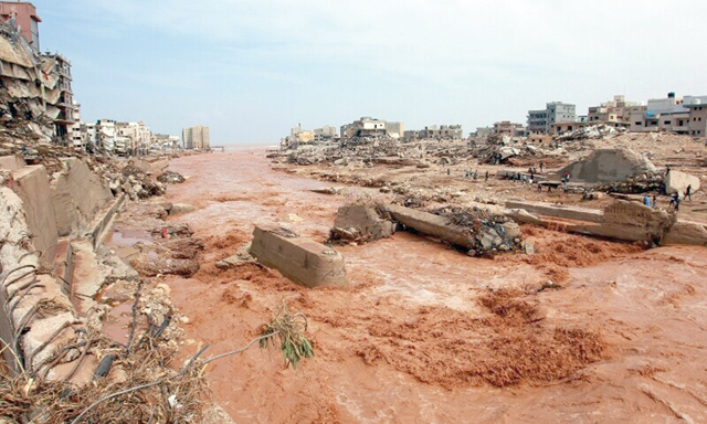 People look at the damage caused by freak floods in Derna, eastern Libya, on September 11 (AFP photo)