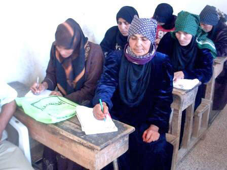 In this undated photo, Jordanian women receive education in a literacy class in a northern town (Photo courtesy of http://kenanaonline.com)