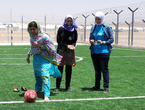 Malala Yousafzai kicks a football at a pitch in the Azraq Refugee Camp, some 100km east of Amman, during a visit on Monday (Photo courtesy of UNICEF)