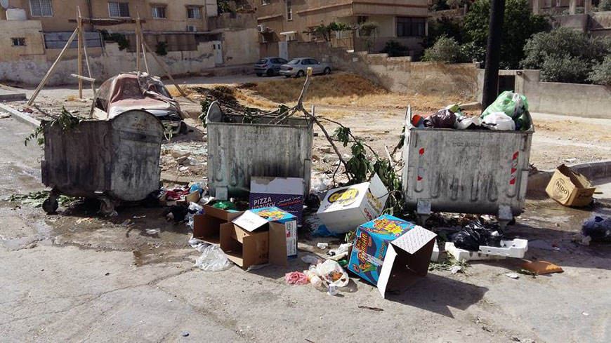 Garbage is seen pilled up near rubbish bins in South Marka on Wednesday  (Photo by Hamzeh Mazraawi)