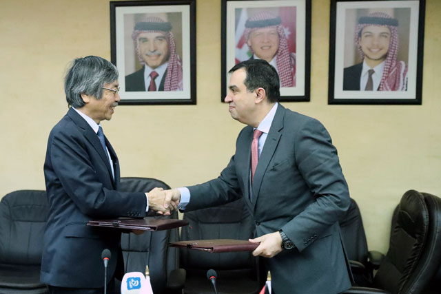 Minister of Planning and International Cooperation Imad Fakhoury shakes hands with Japanese Ambassador to Jordan Shuichi Sakurai after signing a grant agreement in Amman on Wednesday  (Photo courtesy of Ministry of Planning and International Cooperation)