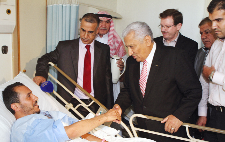 Prime Minister Abdullah Ensour on Friday visits a Ramtha resident who was injured when a stray shell from Syria fell in the yard at his family home (Petra photo)