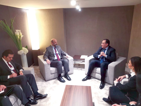 Prime Minister Omar Razzaz meets with Egypt’s Premier Mostafa Madbouly during his participation in the World Economic Forum in Davos, Switzerland, on Wednesday (Photo courtesy of Prime Ministry)