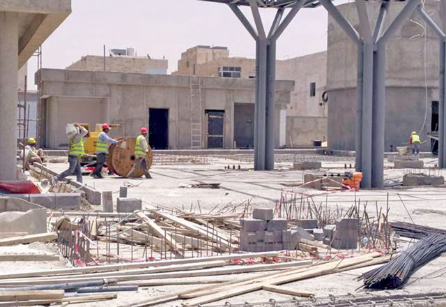 In this undated photo, construction workers can be seen carrying construction materials for a new building (JT file photo)