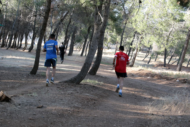 Young men jog at Al Hussein Youth City in Amman on Monday (Photo by Osama Aqarbeh)