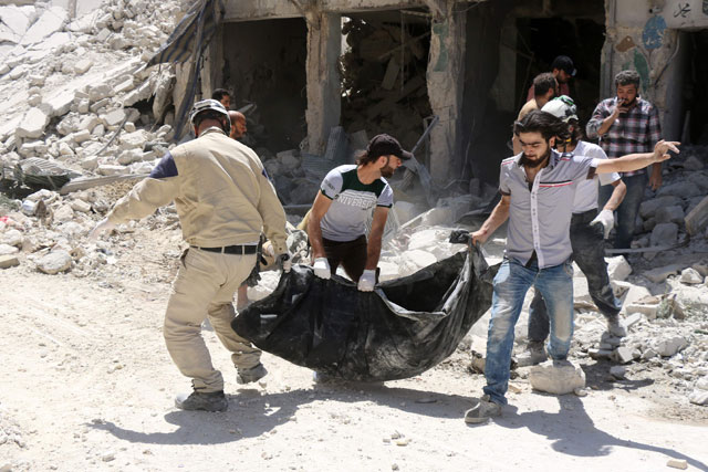 Syrians, including civil defence workers, evacuate a body from the rubble of a building following reported Russian-Syrian regime air strikes on Thursday in Aleppo's rebel held neighbourhood of Tariq Al Bab (AFP photo by Thaer Mohammed)