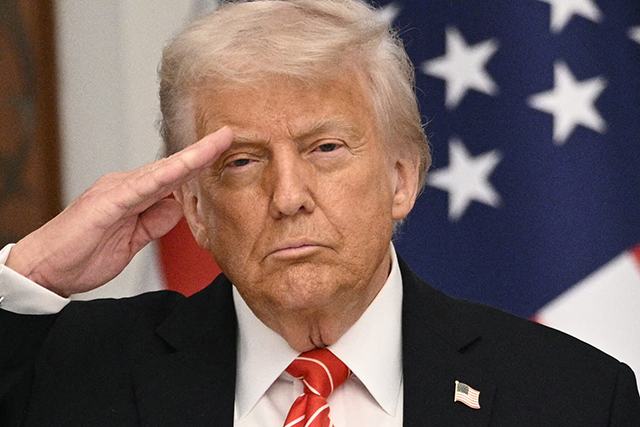 US President Donald Trump salutes during the playing of the US national anthem ahead of a state dinner at the Lusail Palace in Doha on May 14, 2025 (AFP photo)