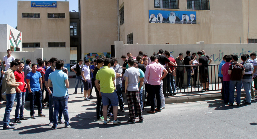 Tawjihi students gather outside an examination hall before the first exam of the summer session on Monday (Photo by Nader Daoud)