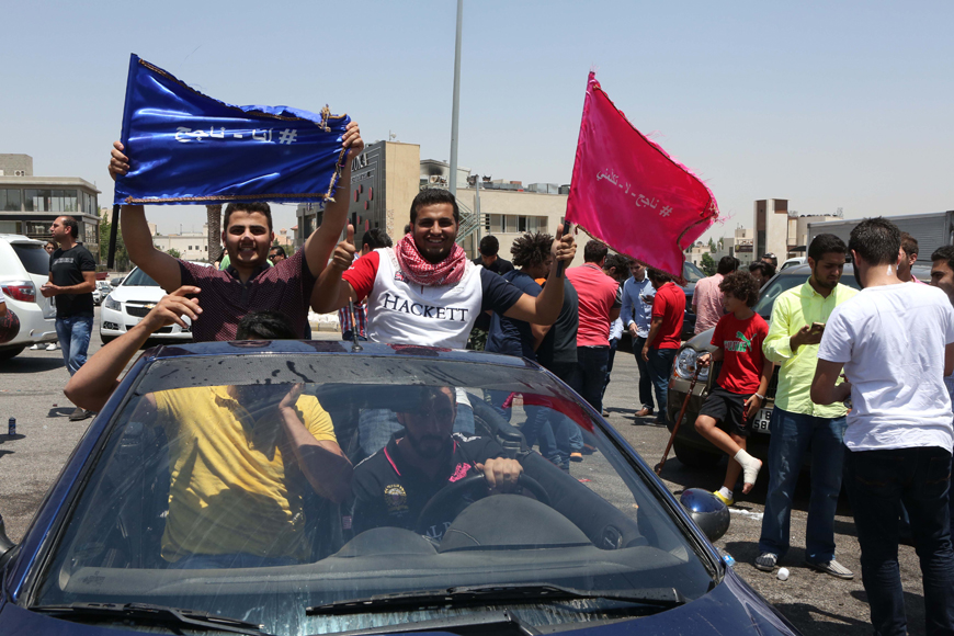 Students celebrate their results in the General Secondary Education Certificate Examination on Tuesday (Photo by Hassan Tamimi)