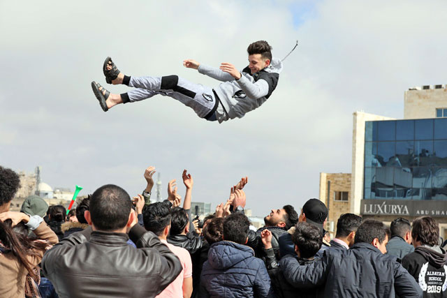Tawjihi (General Secondary Education Certificate Examination) students celebrate the results of their examinations on Saturday (Photo by Osama Aqarbeh)