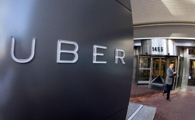 In this December 16, 2014 photo, a man leaves the headquarters of Uber in San Francisco (AP photo)