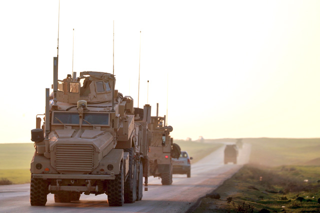 US Marine Corps tactical vehicles are seen driving along a road near the town of Tal Baydar in the countryside of Syria’s northeastern Hasakeh province on Friday (AFP photo)