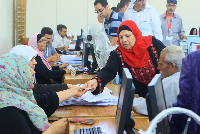 A woman registers to vote in local elections at a polling station in Amman on Tuesday (Petra photo)