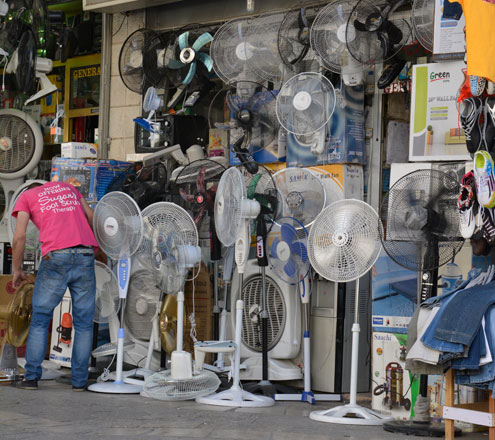 Fans are on display at a shop in Amman recently. People’s growing reliance on fans and air conditioners is putting an extra load on the power grid during hot spells  (Photo by Amjad Ghsoun)