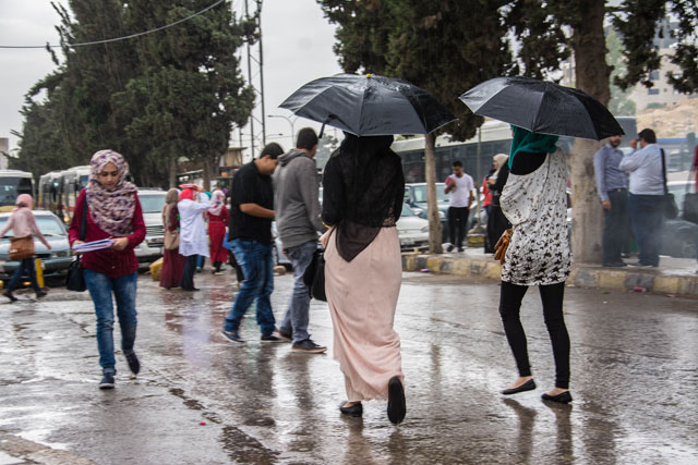 University of Jordan students walk under the rain in Amman in October last year. October's rain constitutes 2 per cent of the country's long-term annual average of rainfall (Photo by Amjad Ghsoun)