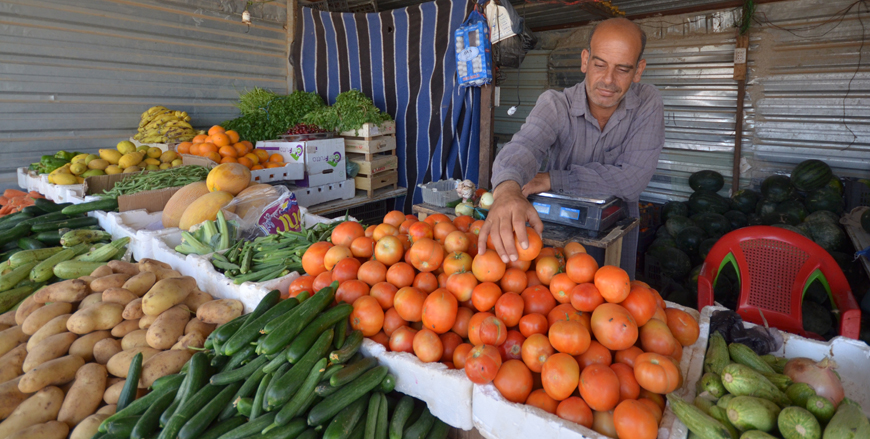 A Syrian refugee sells vegetables at the Zaatari Refugee Camp, some 90km northeast of Amman, earlier this year (Photo by Muath Freij)