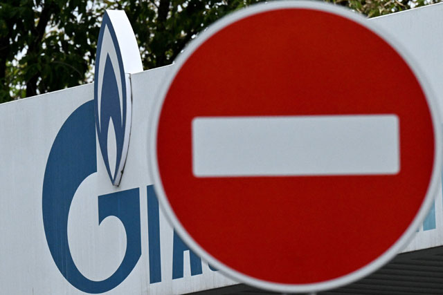 This photograph taken on Friday shows a traffic sign and a logo of Russia's energy company Gazprom at a petrol station in Moscow (AFP photo)