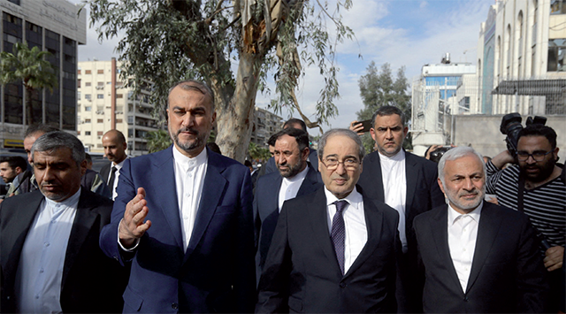 Iranian Foreign Minister Hossein Amir-Abdollahian (centre left) walks alongside his Syrian counterpart Faisal Mekdad (centre right) and Iran's Ambassador to Syria Hossein Akbari (centre) during a visit to the site of a consular annex to the Iranian embassy destroyed in strikes, before inaugurating a new consular building nearby in Damascus on Monday (AFP photo)