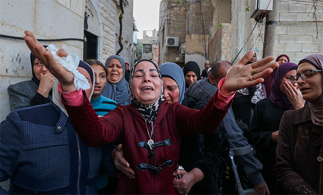 Mourners react during the funeral of Palestinians killed in an Israeli raid earlier in the day, during their funeral in Jenin city in the occupied West Bank, on Thursday (AFP photo)