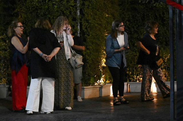 Hotel guests gather outside their hotel after an earthquake in Amritsar on Tuesday (AFP photo)