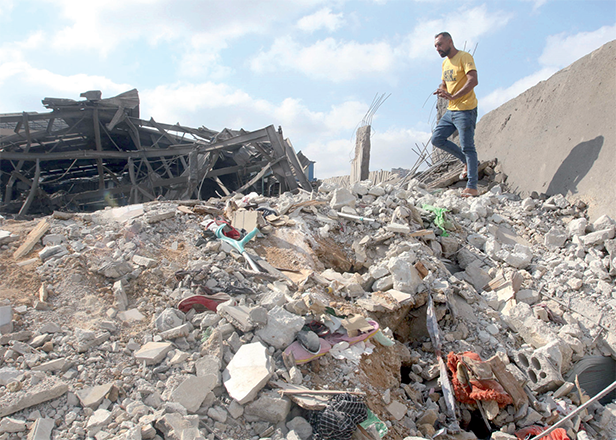 A man inspects the damage to a building after an Israeli strike in the southern town of Kfour, in the Nabatiyeh district, on Saturday (AFP photo)