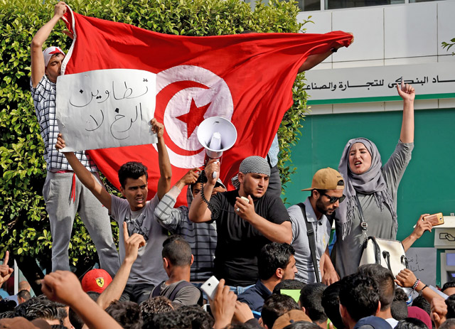 Tunisians shout slogans against the government during a demonstration to show their support to protesters in the southern Tataouine region on Habib Bourguiba avenue in Tunis on Monday (AFP photo)
