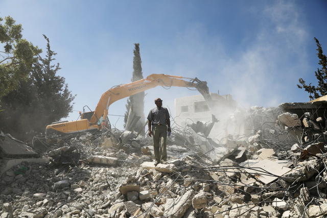 Palestinian Jihad Shawamreh stands on the ruins of his house that he demolished to not face the prospect of Israeli settlers moving in after he lost a land ownership case in Israeli courts, in the East Jerusalem neighbourhood of Beit Hanina, on Thursday (Reuters  photo)