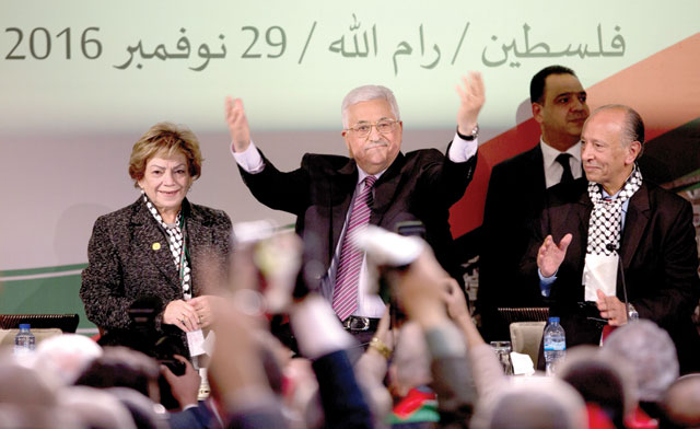 Palestinian President Mahmoud Abbas (centre) is greeted by fellow Fateh members as he arrives during the second day of the Fateh Party conference in Ramallah, on Wednesday (AP photo)