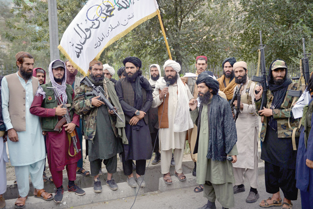 Taliban fighters gather along a street during a rally in Kabul on Tuesday as they celebrate after the US pulled all its troops out of the country (AFP photo)