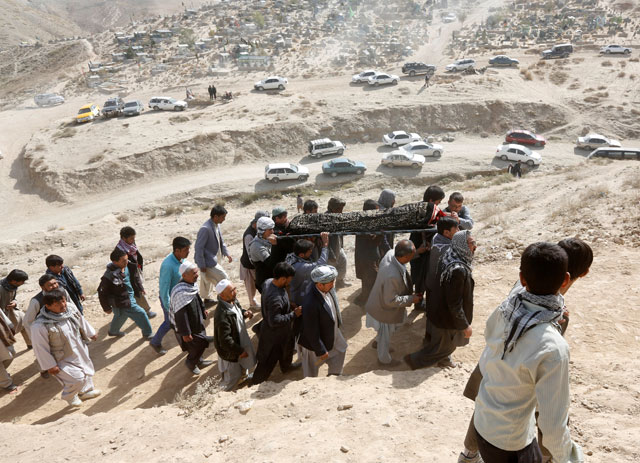 Afghan men carry the coffin of a victim who was killed in last night's suicide attack at the mosque, in Kabul, Afghanistan, on Saturday (AFP photo)