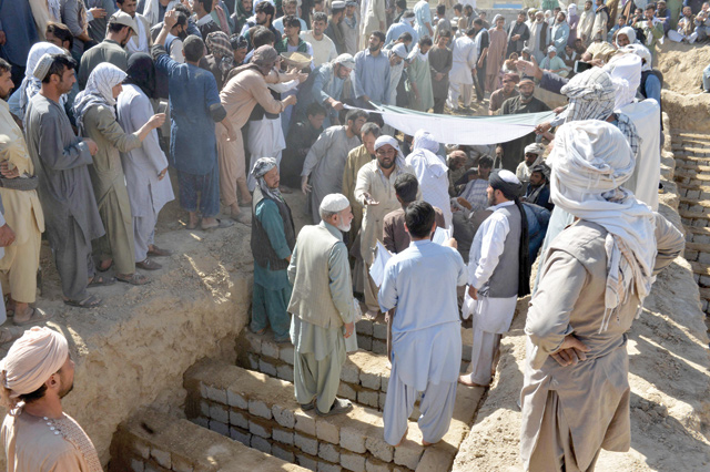 People gather during the burial of victims at a graveyard in Kandahar on Saturday, a day after 41 people were killed and scores were injured in a suicide bomb attack claimed by Daesh in a Shiite mosque in Kandahar (AFP photo)