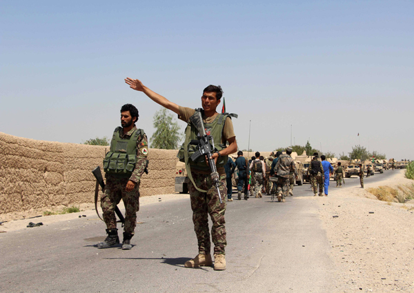 An Afghan National Army soldier gestures as the Afhgan forces arrive in Nad Ali district of Helmand province, southern Afghanistan, on Wednesday (Reuters photo)