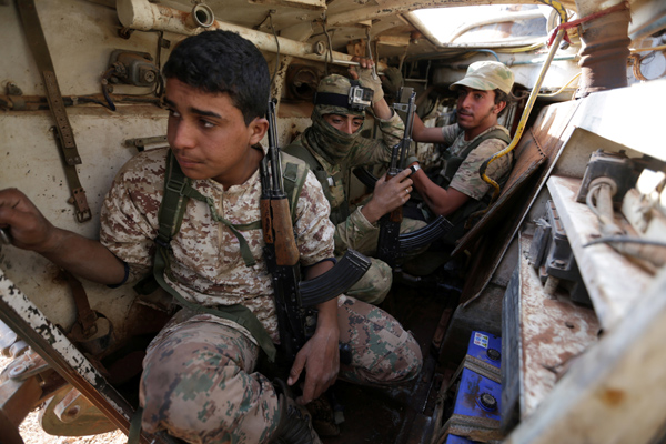 Rebel fighters ride a military vehicle on the outskirts of the Syria Democratic Forces-controlled Tall Rifaat town, northern Aleppo province, Syria, on Saturday (Reuters photo)