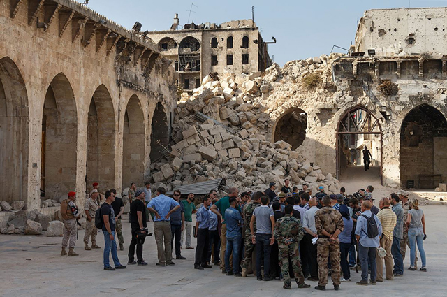 This handout photo provided by the Russian defence ministry on Wednesday shows Russian and other foreign journalists during a press tour in the ancient Great Umayyad Mosque in the old city of Aleppo (AFP photo)
