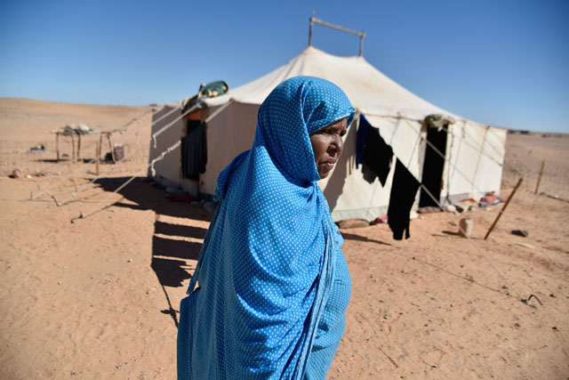 This file photo taken on October 20 shows Sahrawi refugee Khelifa Maleh walking past her tent at the Boujdour camp for Sahrawi refugees on the outskirts of Tindouf, south west of Algeria (AFP photo)