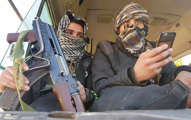 Rebels are seen in a bus as they are evacuated from the town of Douma, eastern Ghouta, in Damascus, Syria, on Sunday (Reuters photo)