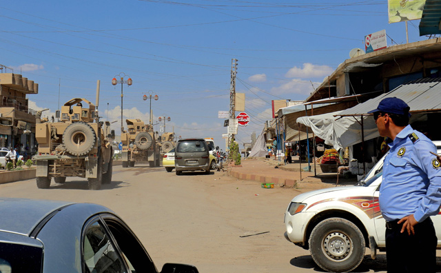 Vehicles from the US-led coalition battling the Daesh group patrol the town of Rmelane in Syria’s Hasakeh province on Tuesday (AFP photo)