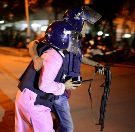 An unidentified security personnel is taken for medical attention after a group of gunmen attacked a restaurant popular with foreigners in a diplomatic zone of the Bangladeshi capital Dhaka, Bangladesh, on Friday (AP photo)
