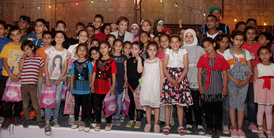 HRH Princess Basma poses for a group photo with the orphan children at the Mabarrat Umm Al Hussein on Monday  (Petra photo)
