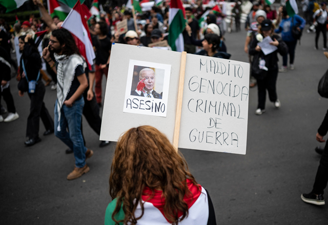 A demonstrator holds a sign with the portraits of US President Joe Biden that reads in spanish 'Murderer' during a pro-Palestinian rally to mark the first anniversary of the Israeli war on Gaza in Mexico City on October 5, 2024 (AFP photo)