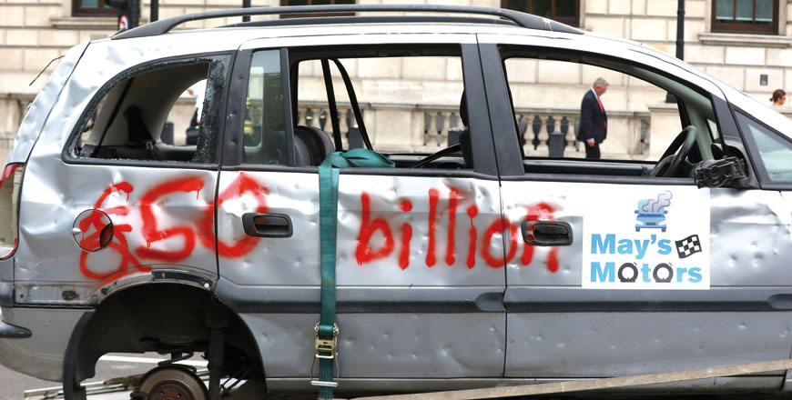 Pro-EU campaign group 'Open Britain' drive a broken car around Parliament Square on a low loader, as the government releases its Brexit 'White Paper', in Westminster, London, Britain, on Thursday (Reuters photo)