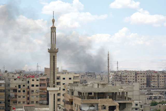 A photo taken on Sunday shows smoke billowing from the Palestinian camp of Yarmouk, south of the Syrian capital Damascus, during regime strikes targeting Daesh in the camp (AFP photo)
