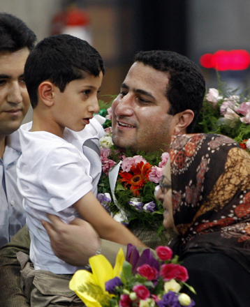 In this July 15, 2010 file photo, Shahram Amiri, an Iranian nuclear scientist greets his son Amir Hossein as he arrives to the Imam Khomeini airport after returning from the United States, outside Tehran, Iran (AP photo)