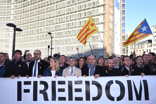 Catalan pro-independence mayors hold a banner as they demonstrate to show solidarity with detained officials in Spain on Tuesday in front of the European Commission building in Brussels (AFP photo)