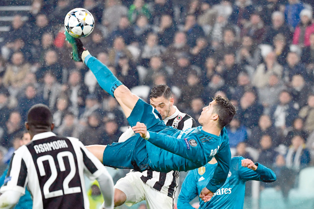 Real Madrid’s Portuguese forward Cristiano Ronaldo (centre) overhead kicks and scores during the UEFA Champions League quarter-final first leg football match between Juventus and Real Madrid in Turin on Wednesday (AFP photo)