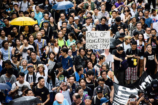 A banner which reads 'Fall of Hong Kong Since 1997' (right) is carried during a protest march in Hong Kong on Saturday, coinciding with the 20th anniversary of the city's handover from British to Chinese rule (AFP photo)