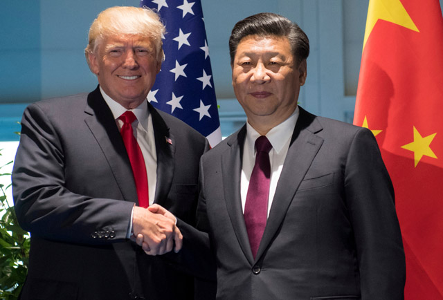 US President Donald Trump and Chinese President Xi Jinping (right) shake hands prior to a meeting on the sidelines of the G-20 summit in Hamburg, Germany, on Saturday (Reuters photo)