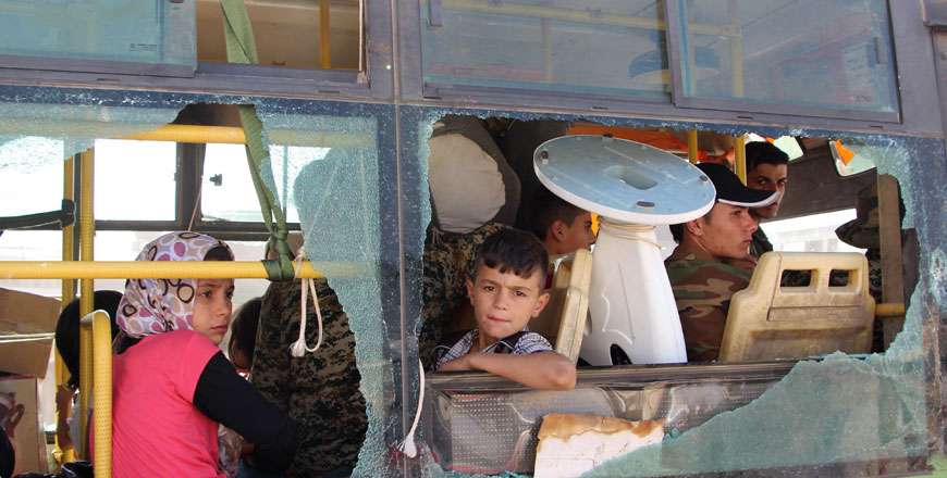 Evacuated Syrians from Al Foua and Kafraya towns in the Idlib province are seen through a broken bus window during evacuations of pro-regime fighters and inhabitants on Thursday (AFP photo)