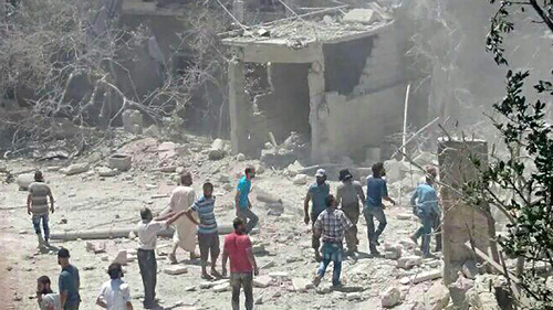 This handout photo released by the international NGO Save the Children on Thursday shows people gathering around the area of a damaged building of a maternity hospital supported by the NGO after it was hit by an air raid in the  rebel-held town of Kafer Takhareem in Idlib province of northwest Syria (AFP photo)